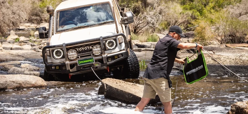 Toyota Landcruiser getting winched out of a river Toyota Landcruiser getting winched out of a river